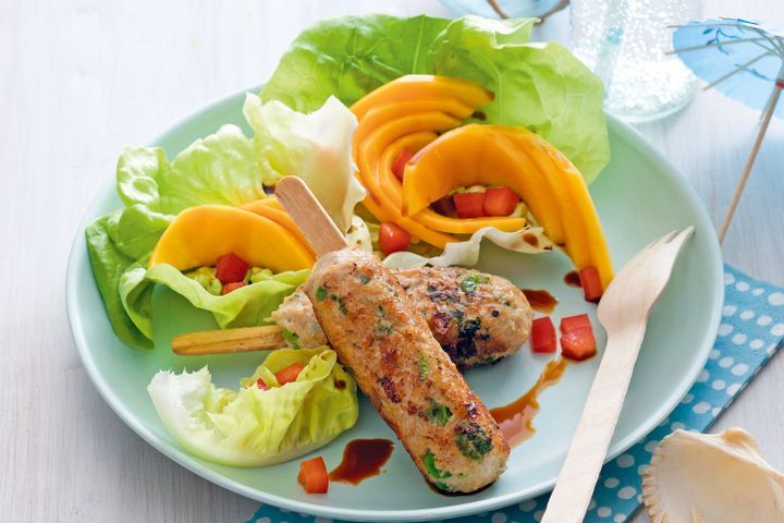 Cooking Meat Barbecued chicken on a stick with mango salad