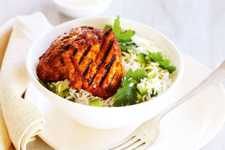 Cooking Meat Indian spiced chicken with rice salad