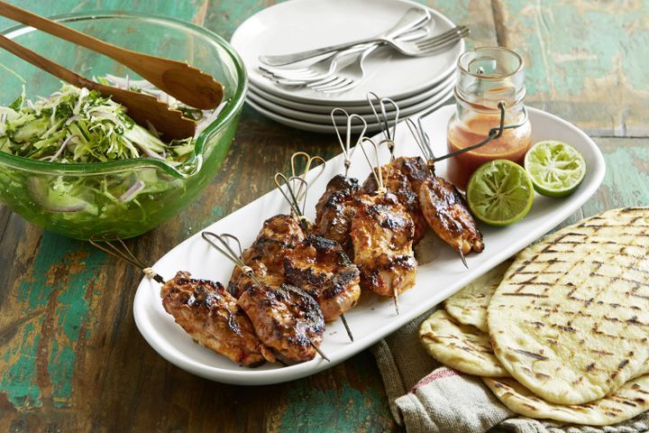 Cooking Meat Piri Piri chicken with slaw and homemade flatbreads