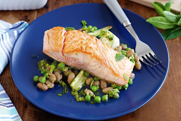 Cooking Meat Salmon with braised fennel, pesto beans and peas