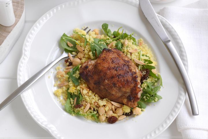 Cooking Meat Spiced chicken thighs with yellow couscous