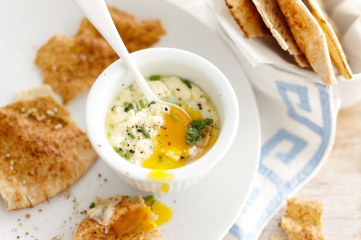 Cooking Eggs Baked eggs with wilted kale and feta with dukkah pita crisps