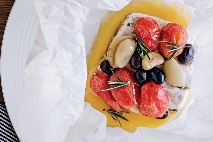 Cooking Fish Barramundi parcels with tomato, garlic and olive confit
