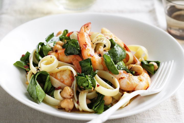 Cooking Fish Fettucine with chilli oil, spinach, prawns and chickpeas