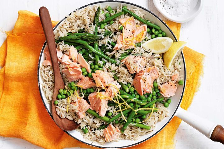 Cooking Fish Pilaf with salmon, asparagus and peas