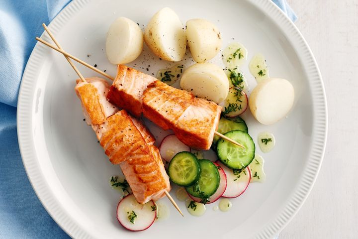 Cooking Fish Salmon kebabs with cucumber and radish dill salad
