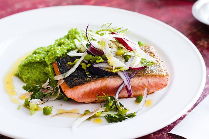 Cooking Fish Salmon with pea mash and fennel salad
