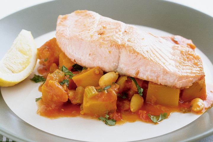 Cooking Fish Salmon with spiced pumpkin and tomatoes