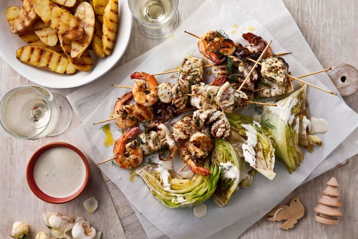 Cooking Fish Seafood skewers with grilled lettuce and blue cheese dressing