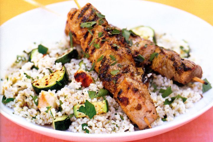 Cooking Meat Barbecued harissa pork on haloumi and zucchini couscous