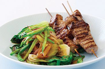 Cooking Meat Chinese-style pork skewers with Asian greens