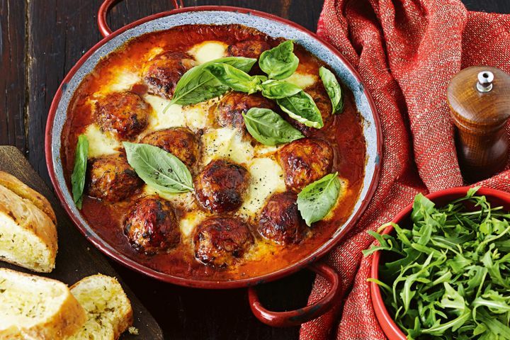 Cooking Meat Oven-baked meatballs in cheesy tomato sauce