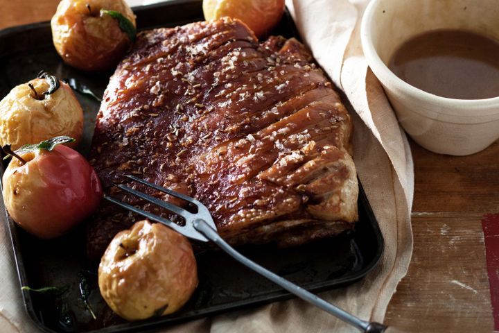 Cooking Meat Pork belly with apple cider vinegar gravy and roasted apples