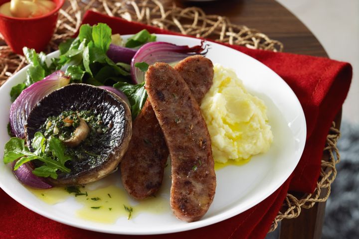 Cooking Meat Pork sausages with mushrooms and herb butter