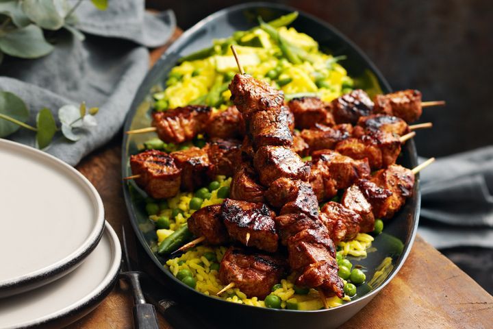 Cooking Meat Pork skewers with bean, pea & zucchini saffron rice