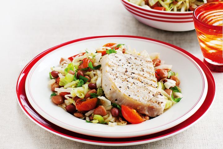 Cooking Meat Pork steaks with warm cabbage and bean salad