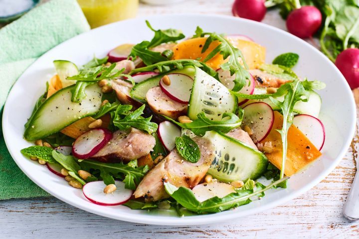 Cooking Meat Radish, carrot, cucumber and mint salad with pork sausages