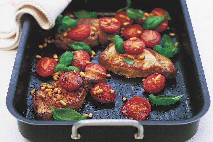 Cooking Meat Roast pork steaks with tomatoes and pine nuts