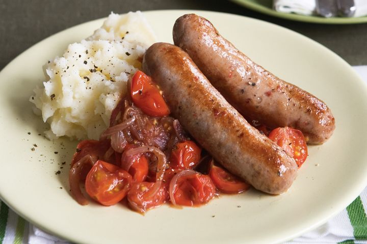 Cooking Meat Sausages with squashed tomatoes and garlic mash