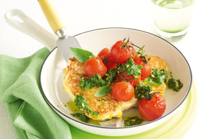 Cooking Vegetarian Corn and ricotta cakes with grilled tomatoes