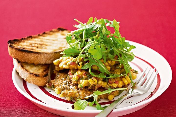 Cooking Vegetarian Corn fritters with rocket and balsamic dressing