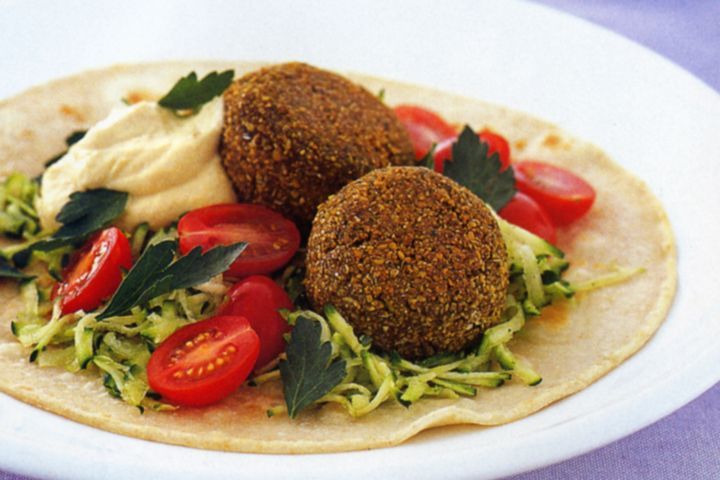 Cooking Vegetarian Falafel and hummus on pita bread