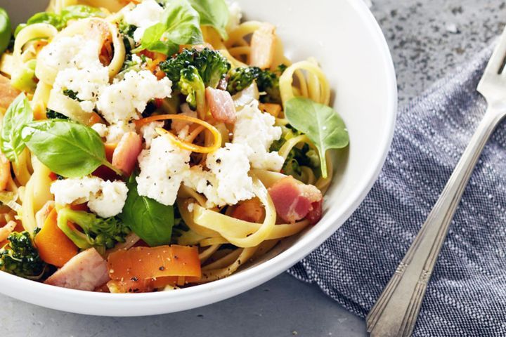 Cooking Vegetarian Fettuccine with carrot ribbons, broccoli and ricotta