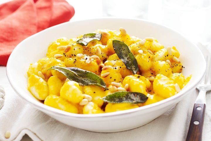 Cooking Vegetarian Gnocchi with roasted pumpkin sauce, pinenuts and sage