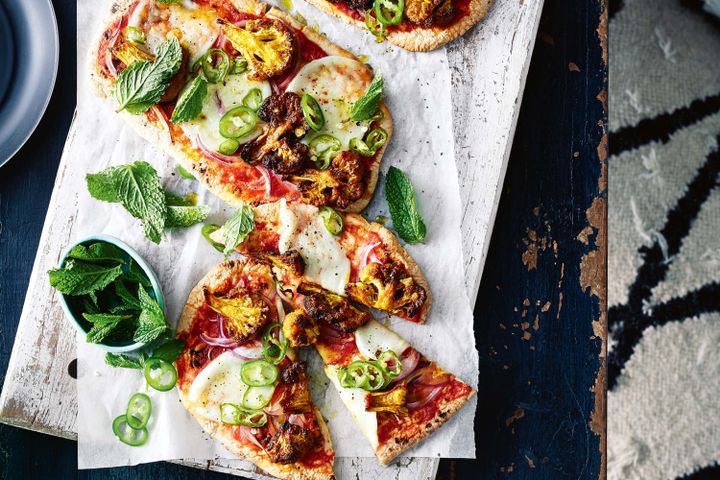 Cooking Vegetarian Indian pizza with curried cauliflower and green chilli