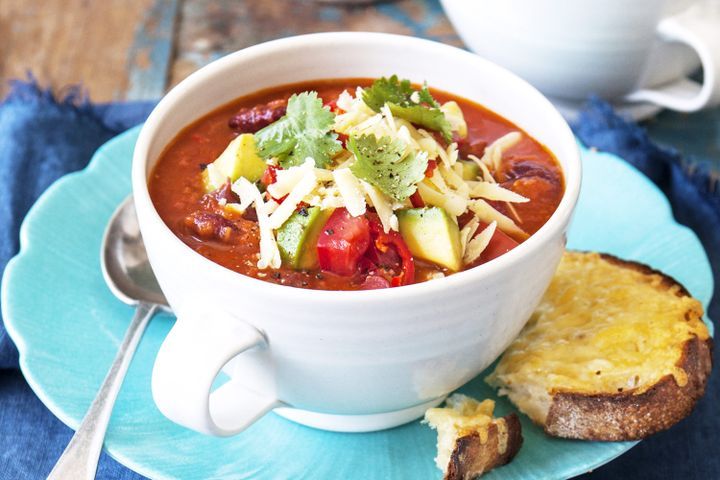 Cooking Vegetarian Mexican tomato and bean soup with cheese toasts