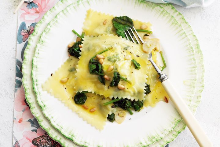 Cooking Vegetarian Ricotta and herb ravioli with spinach and pine nuts