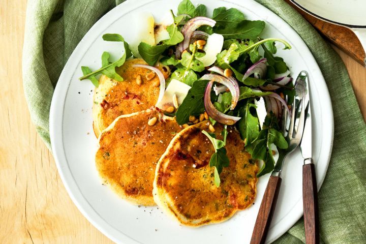 Cooking Vegetarian Ricotta and semi-dried tomato pancakes with rocket salad