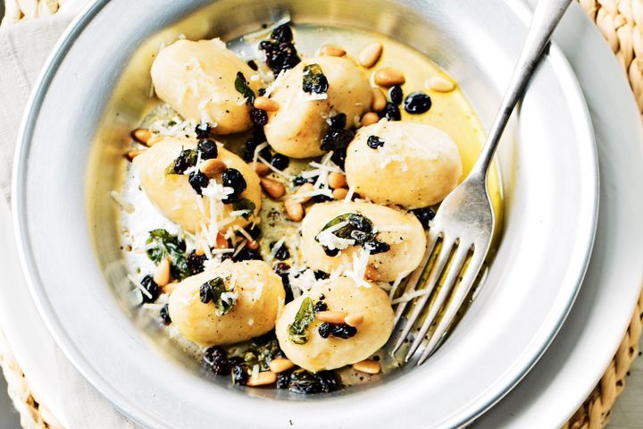 Cooking Vegetarian Ricotta gnudi with pine nuts, currants and oregano