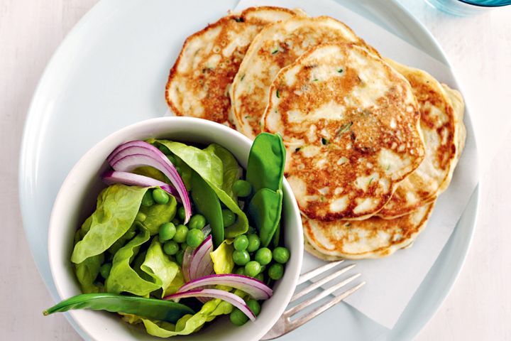 Cooking Vegetarian Zucchini and mint ricotta pancakes with pea salad