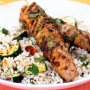 Barbecued harissa pork on haloumi and zucchini couscous