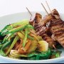 Chinese-style pork skewers with Asian greens