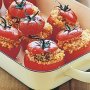 Couscous-stuffed tomatoes with yoghurt and mint sauce