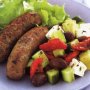 Oregano pork sausages with Greek salad