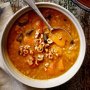 Pumpkin and barley soup with crushed hazelnuts
