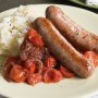 Sausages with squashed tomatoes and garlic mash