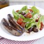 Spicy sausages with roasted tomato salad