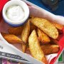 Vegetable wedges with spiced sour cream