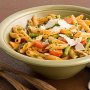Warm penne pasta salad with chicken, asparagus and pesto rosso